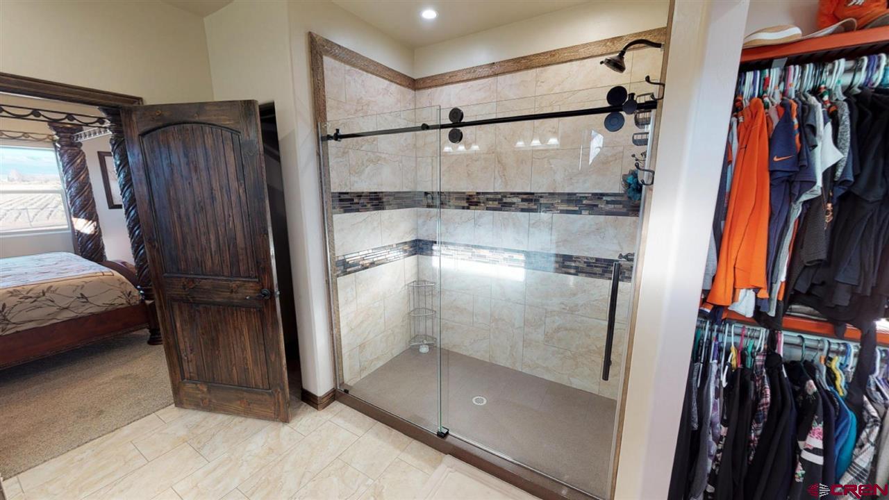 8370 2000th Road Austin, CO 81410 - Photo 19 of 35 a view of walk in closet with clothes and shoes