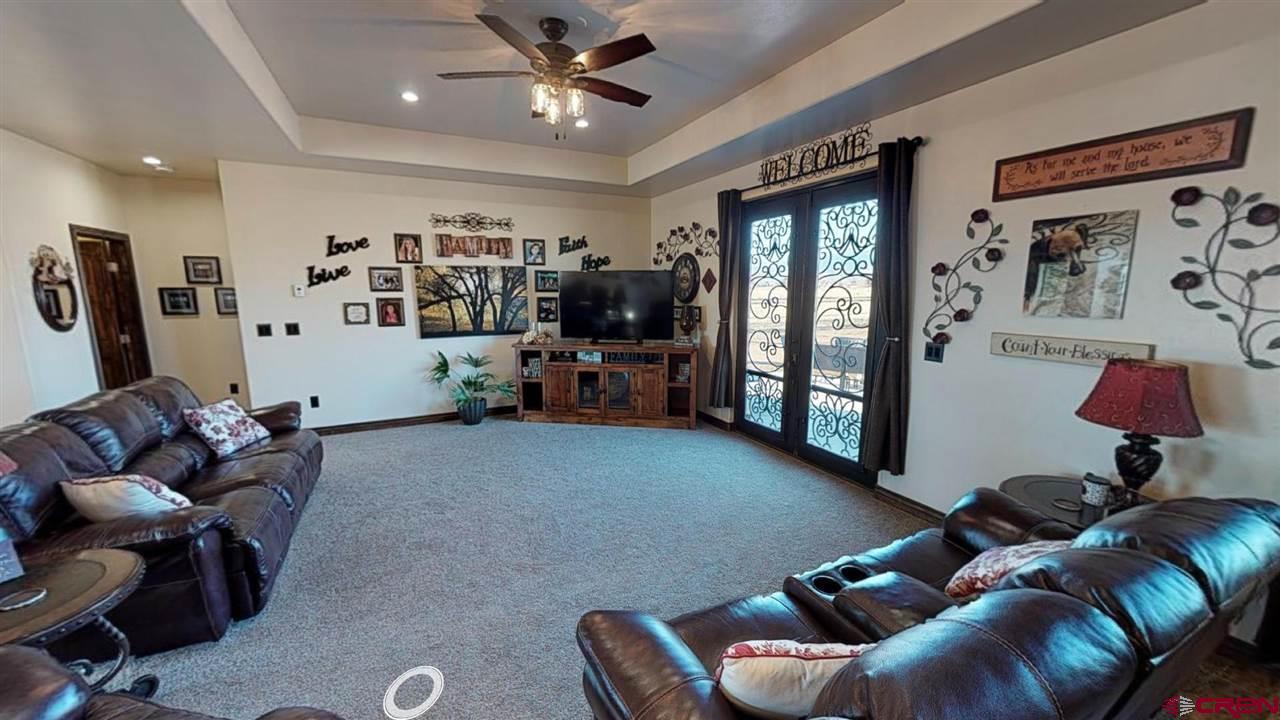 8370 2000th Road Austin, CO 81410 - Photo 20 of 35 a living room with furniture gym equipment and a window