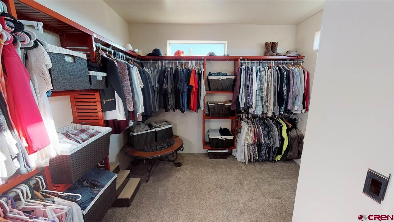 8370 2000th Road Austin, CO 81410 - Photo 22 of 35 a view of walk in closet with clothes and shoes