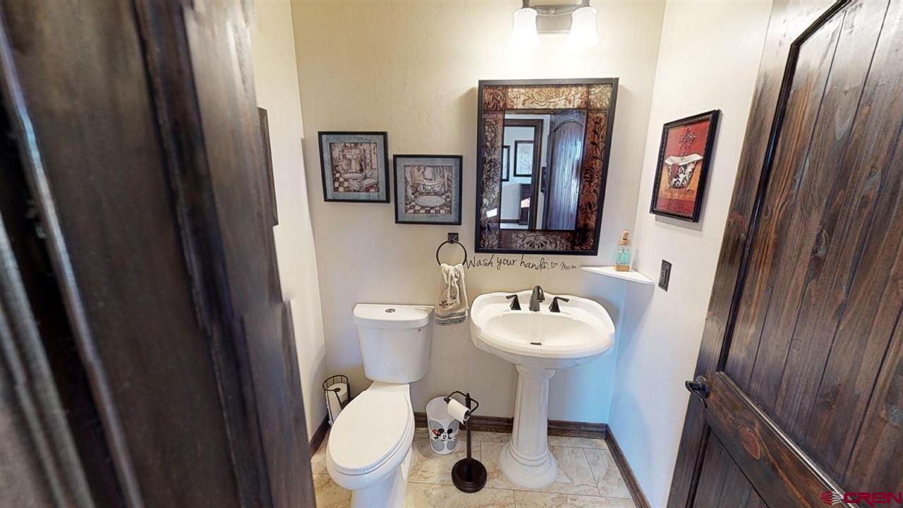 8370 2000th Road Austin, CO 81410 - Photo 25 of 35 a bathroom with a sink mirror and toilet
