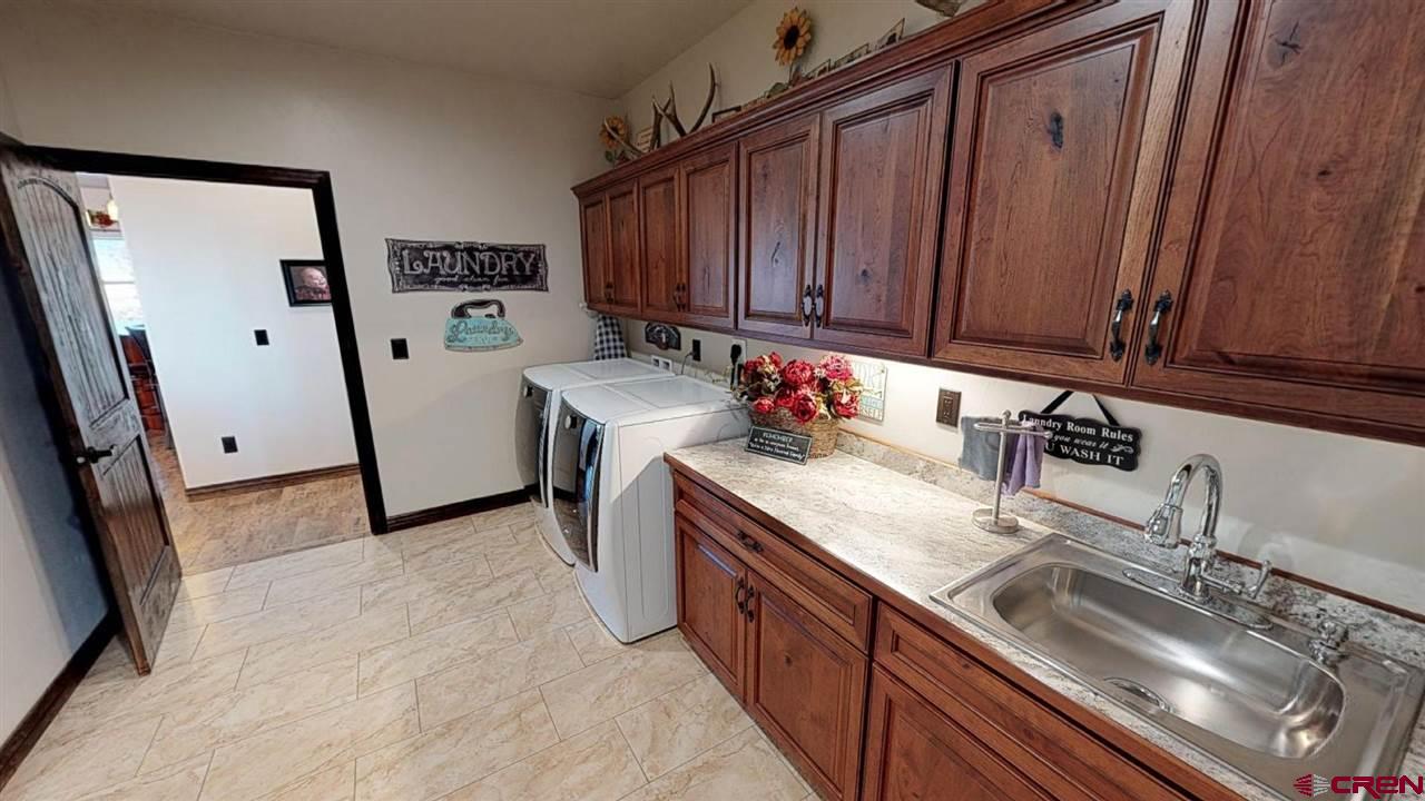 8370 2000th Road Austin, CO 81410 - Photo 30 of 35 a kitchen with granite countertop a sink stove and cabinets