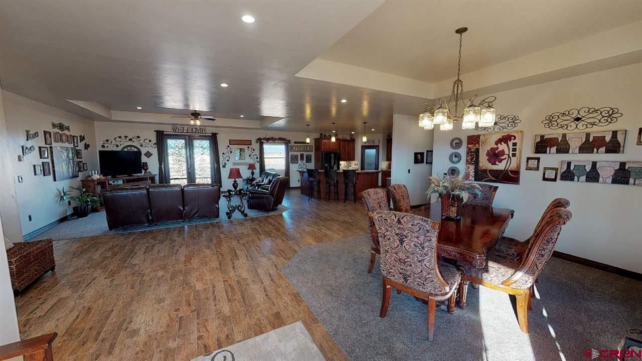 8370 2000th Road Austin, CO 81410 - Photo 5 of 35 a living room with lots of furniture and chandelier