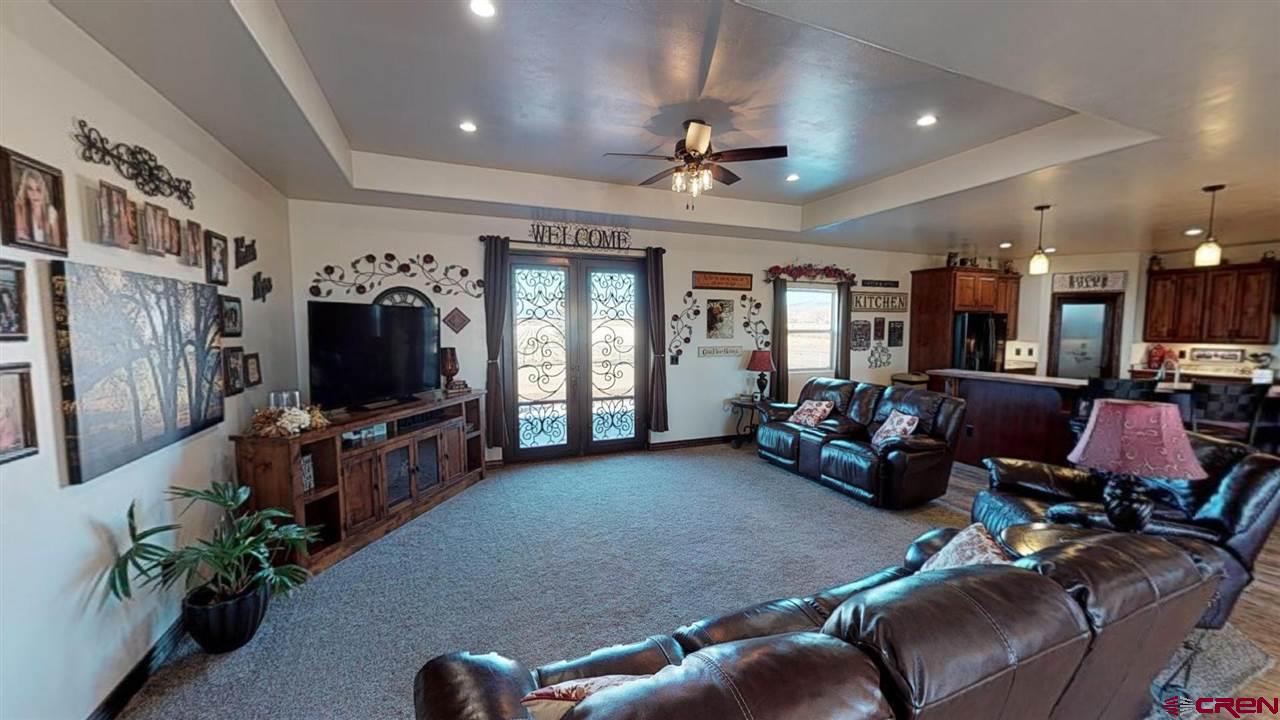 8370 2000th Road Austin, CO 81410 - Photo 6 of 35 a living room with furniture and a flat screen tv