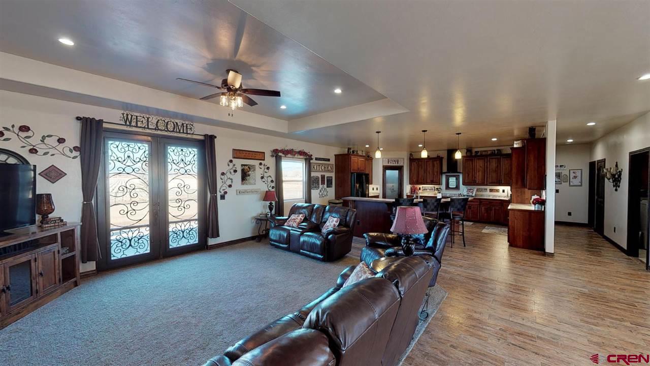 8370 2000th Road Austin, CO 81410 - Photo 7 of 35 a living room with furniture and a flat screen tv
