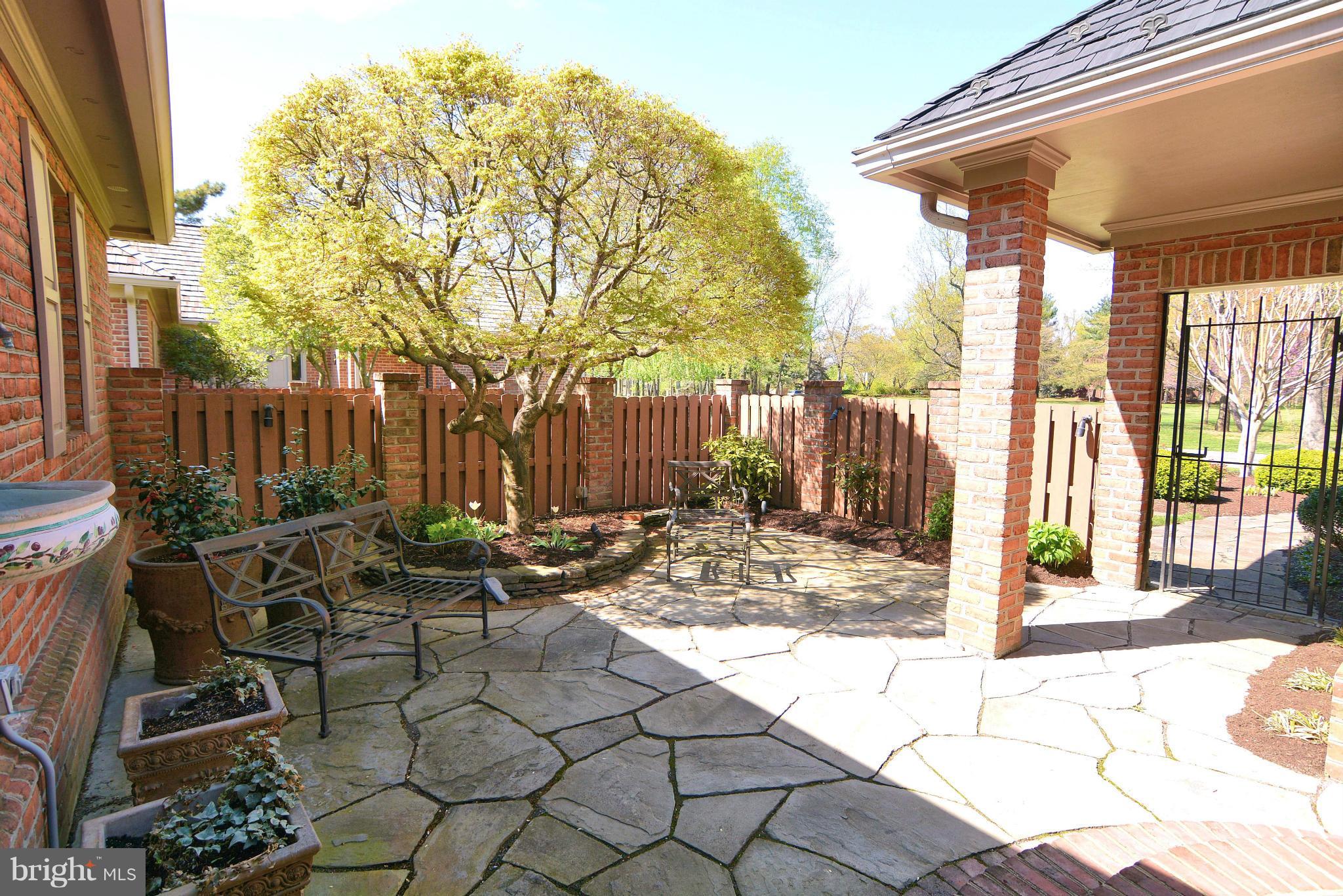 1040 South River Landing Road, Unit 1040 Edgewater, MD 21037 - Photo 2 of 30 a view of a patio with table and chairs and wooden fence
