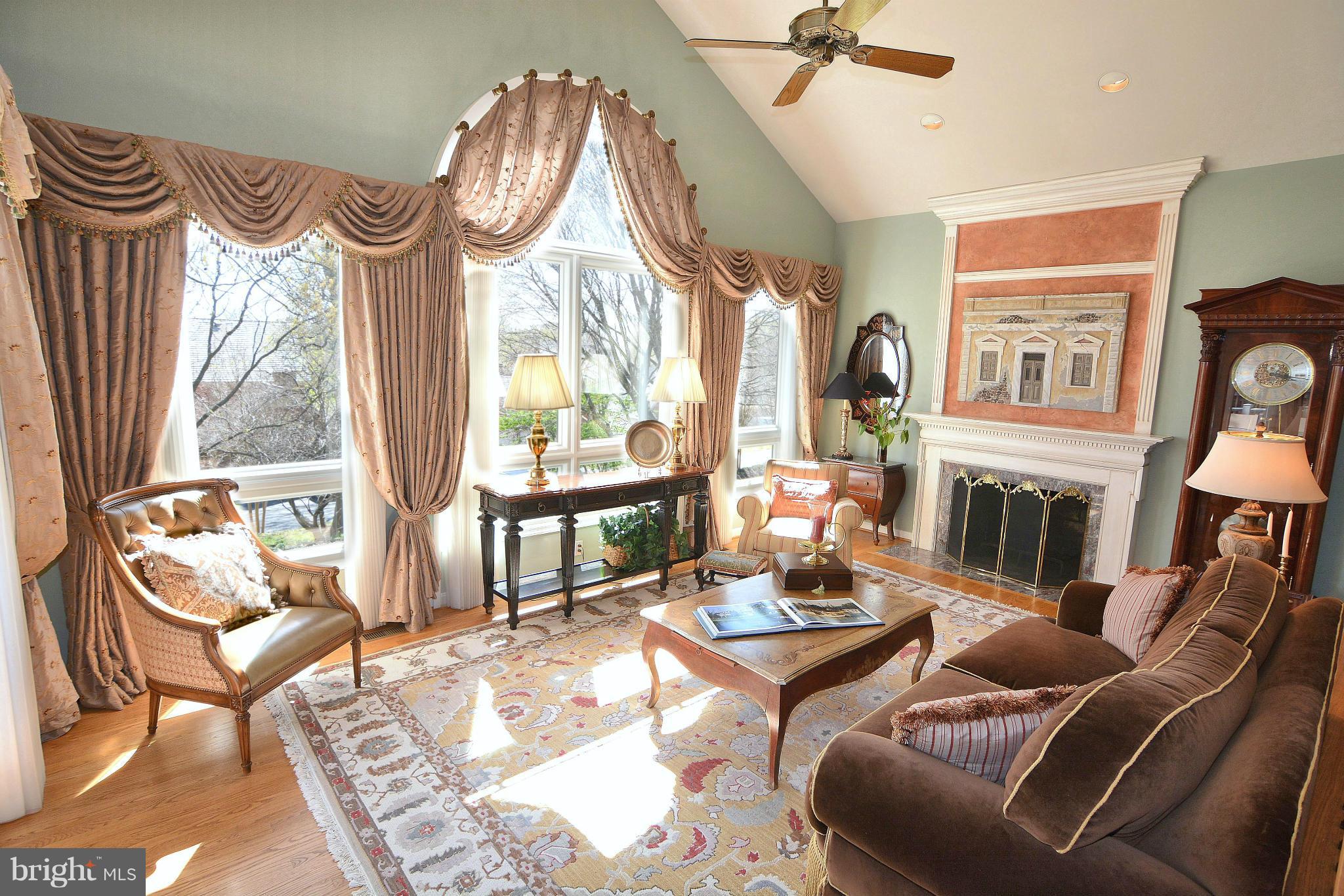 1040 South River Landing Road, Unit 1040 Edgewater, MD 21037 - Photo 13 of 30 a living room with furniture a fireplace and a floor to ceiling window