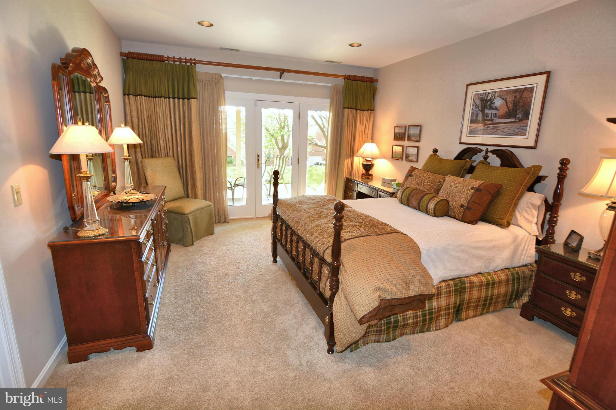 1040 South River Landing Road, Unit 1040 Edgewater, MD 21037 - Photo 18 of 30 a spacious bedroom with a bed a chandelier and large window