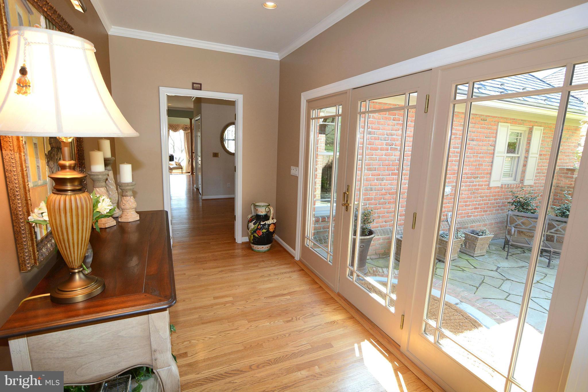 1040 South River Landing Road, Unit 1040 Edgewater, MD 21037 - Photo 3 of 30 a view of a hallway with wooden floor and a living room