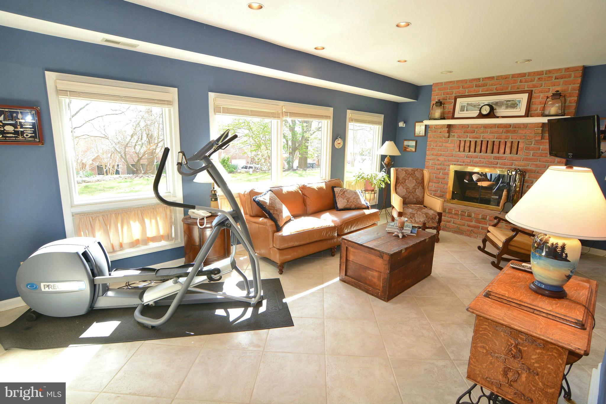 1040 South River Landing Road, Unit 1040 Edgewater, MD 21037 - Photo 24 of 30 a living room with furniture a fireplace and a large window