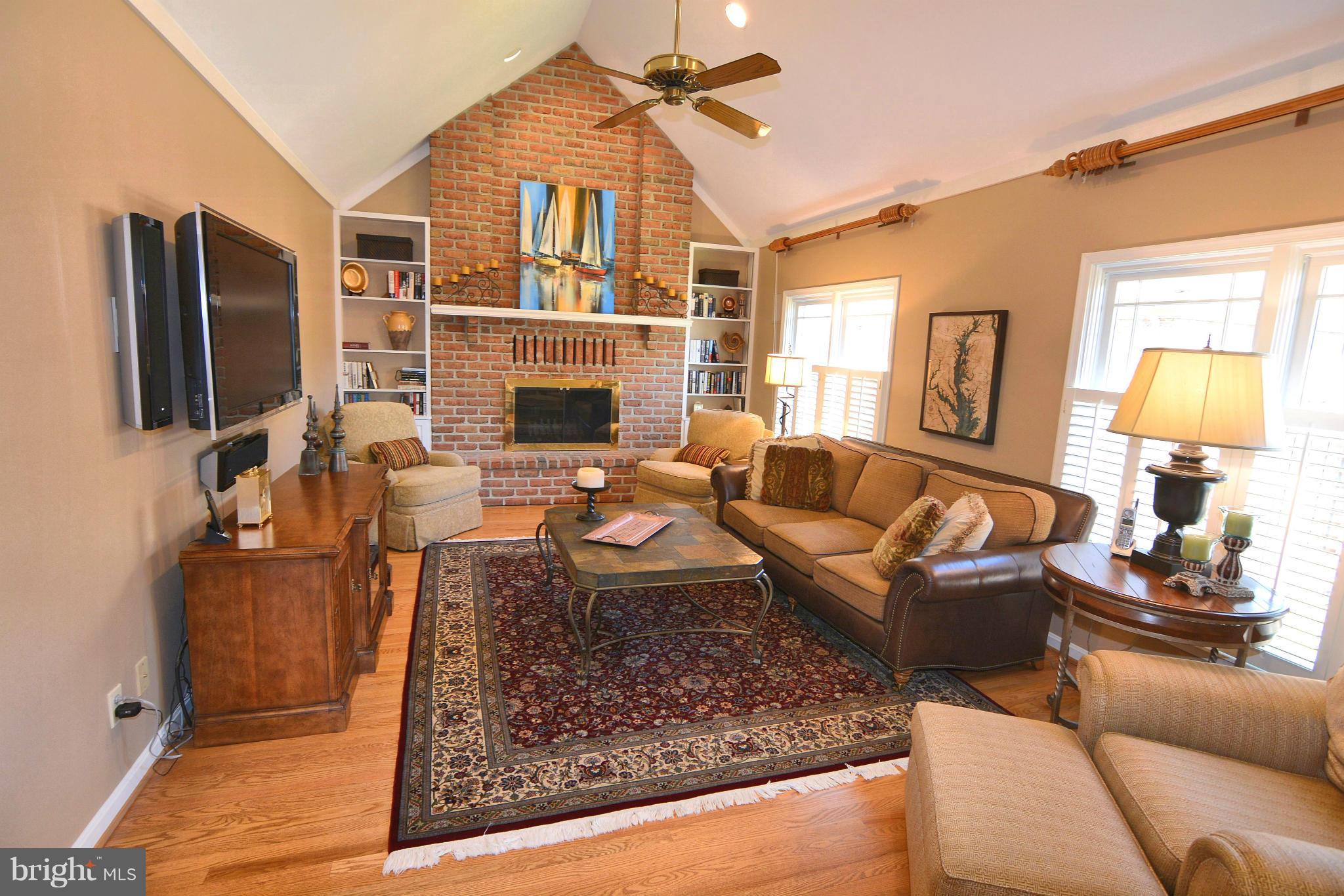 1040 South River Landing Road, Unit 1040 Edgewater, MD 21037 - Photo 4 of 30 a living room with furniture a fireplace and a flat screen tv