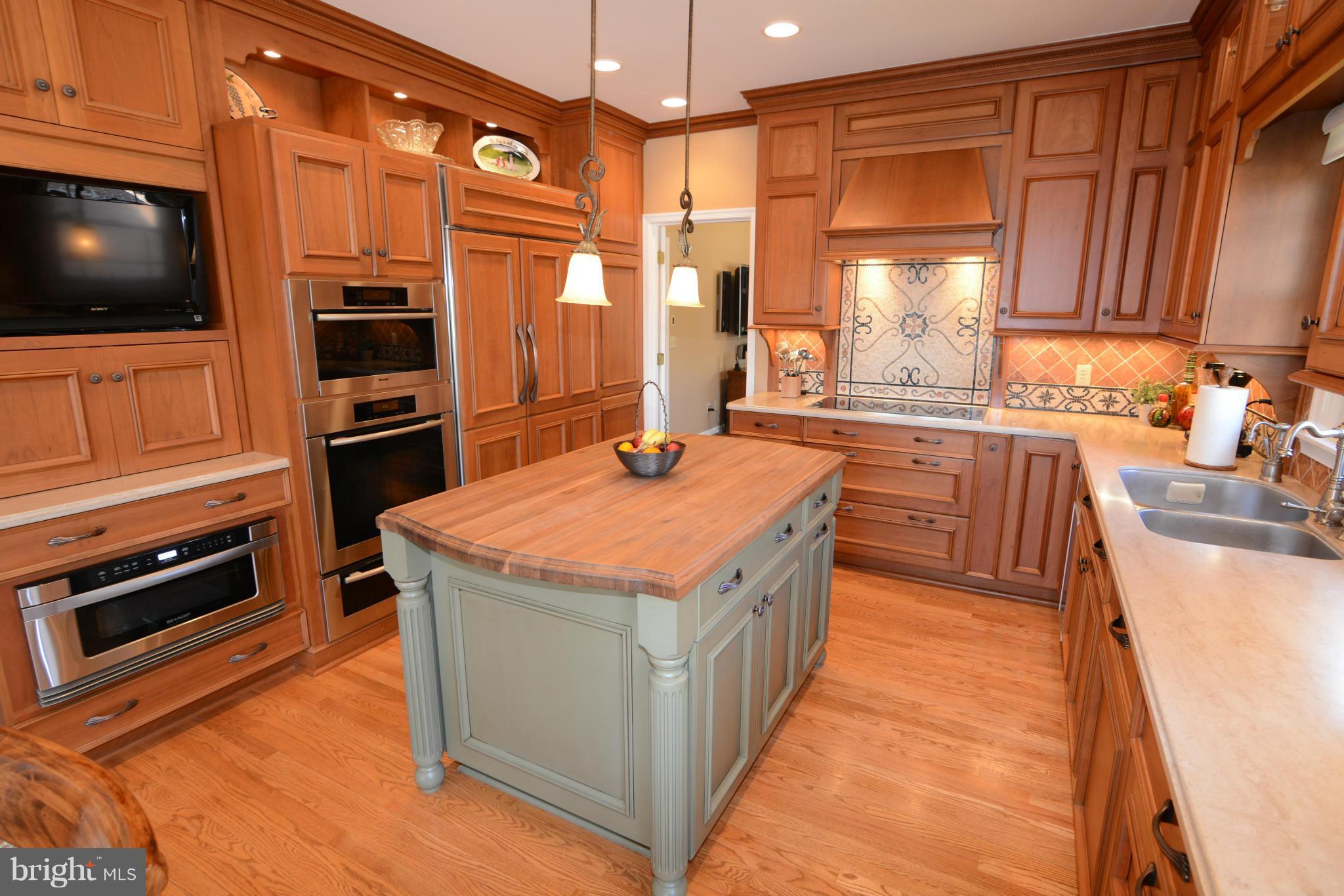 1040 South River Landing Road, Unit 1040 Edgewater, MD 21037 - Photo 6 of 30 a kitchen with stainless steel appliances granite countertop a stove a sink and a microwave