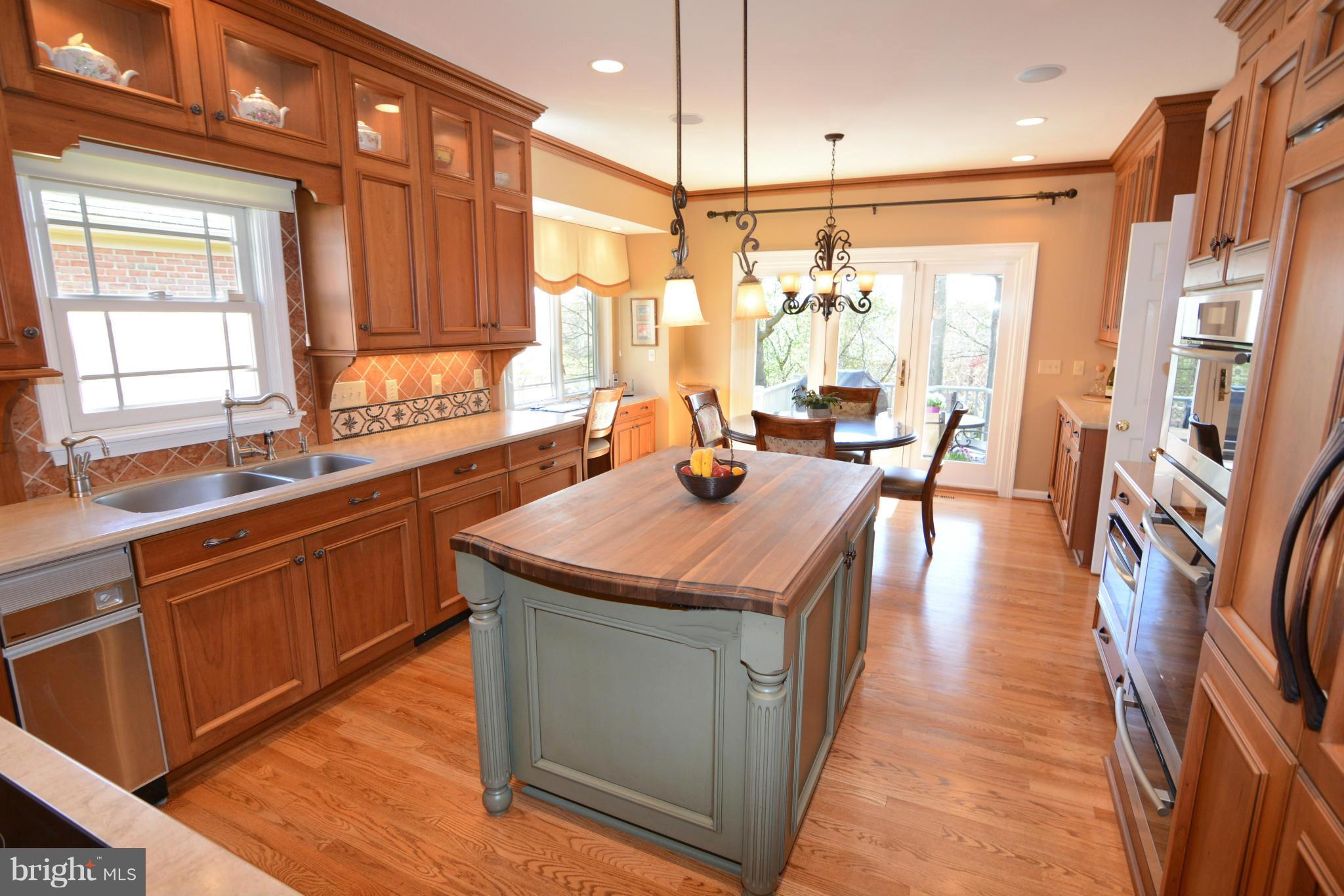 1040 South River Landing Road, Unit 1040 Edgewater, MD 21037 - Photo 7 of 30 a kitchen with stainless steel appliances granite countertop a sink a stove and a wooden floors