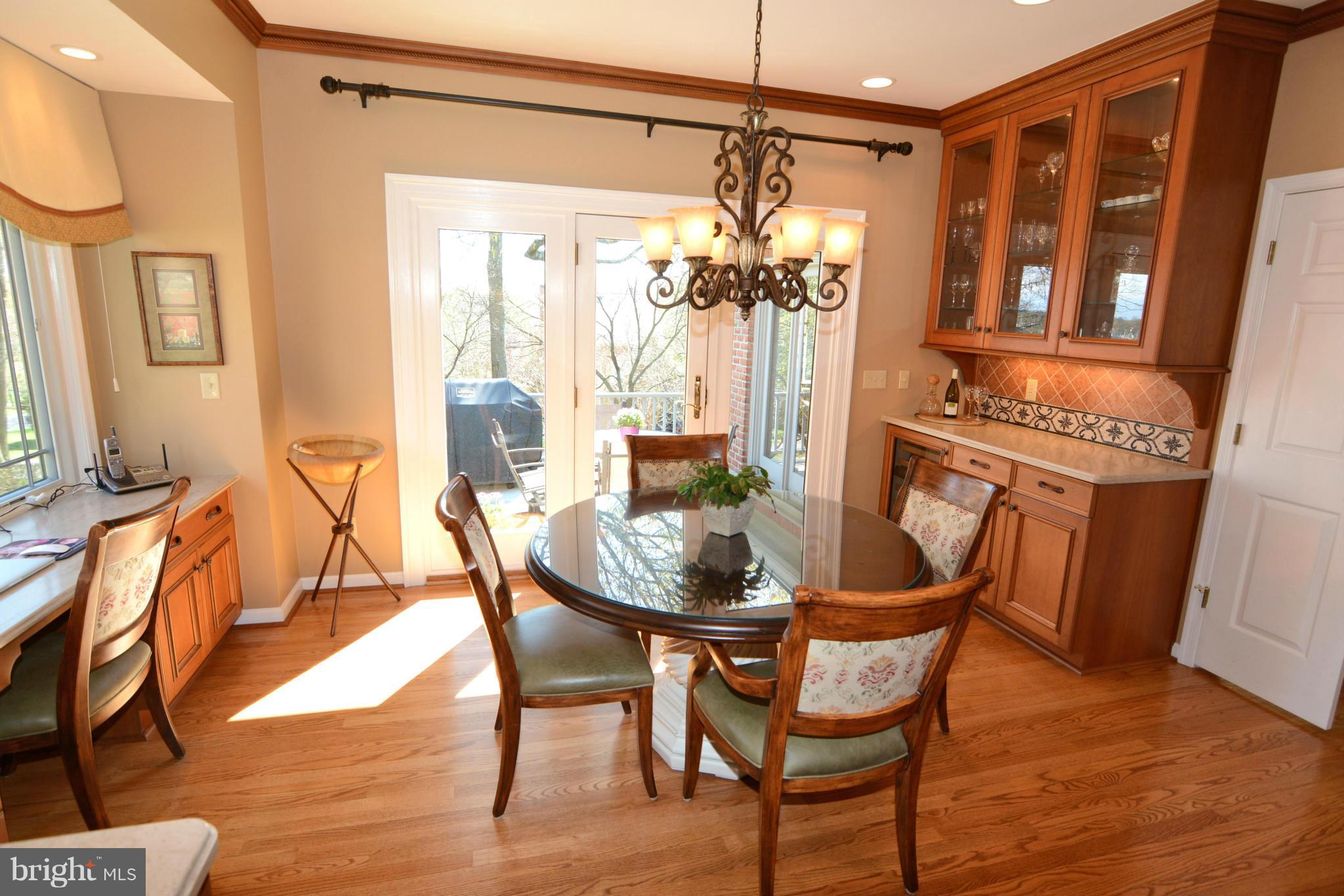 1040 South River Landing Road, Unit 1040 Edgewater, MD 21037 - Photo 8 of 30 a dining room with furniture a chandelier and wooden floor