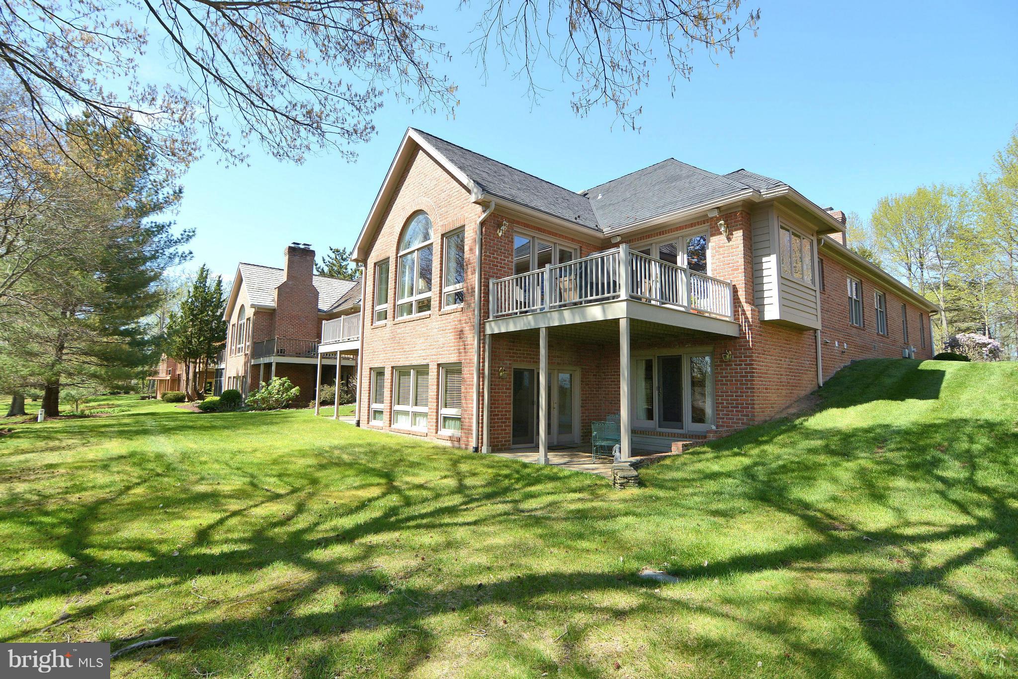 1040 South River Landing Road, Unit 1040 Edgewater, MD 21037 - Photo 10 of 30 a view of a big house with a big yard and large trees