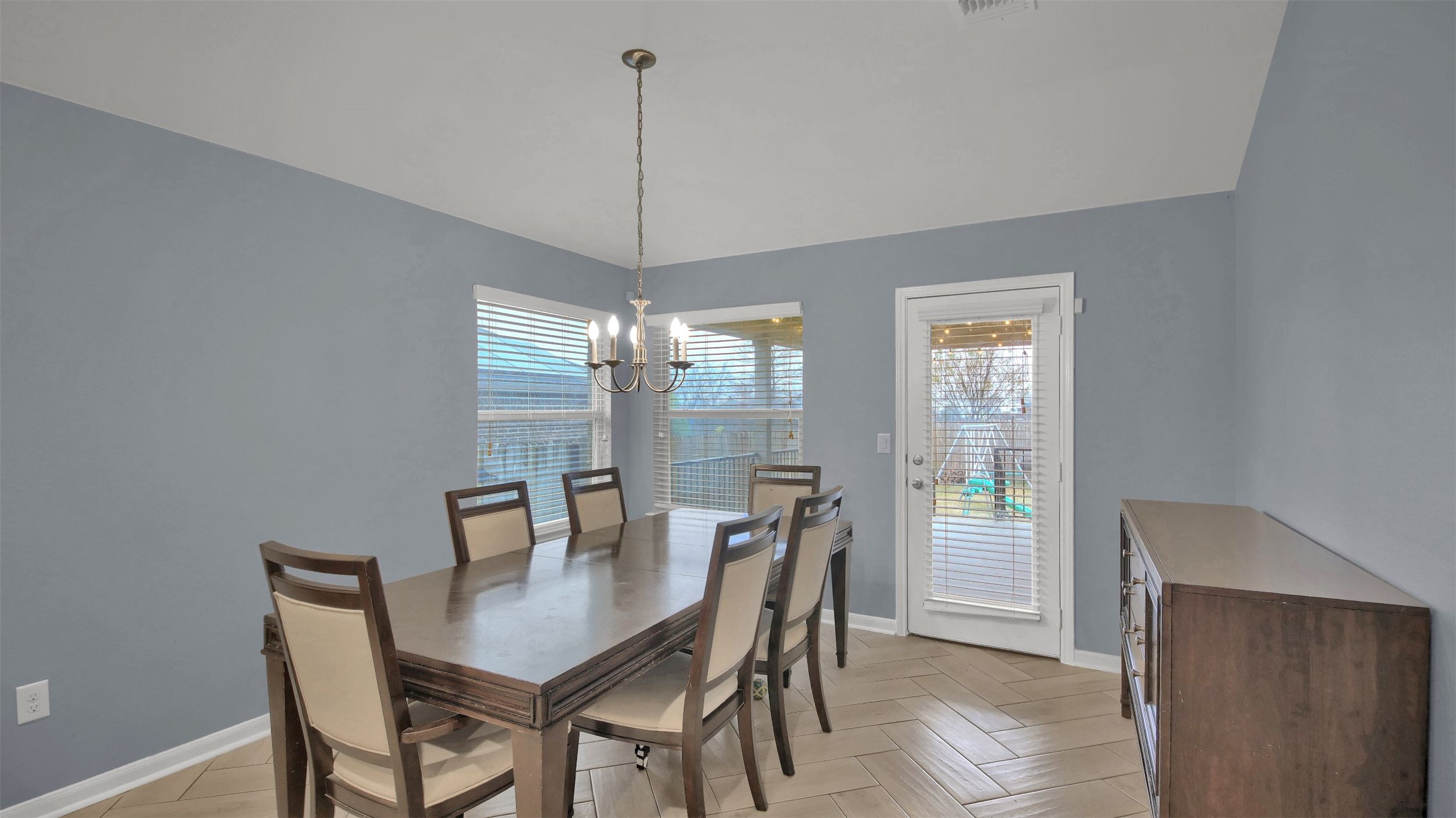 18005 Moreto Loop Pflugerville, TX 78660 - Photo 11 of 25 Dining space featuring parquet flooring and a chandelier