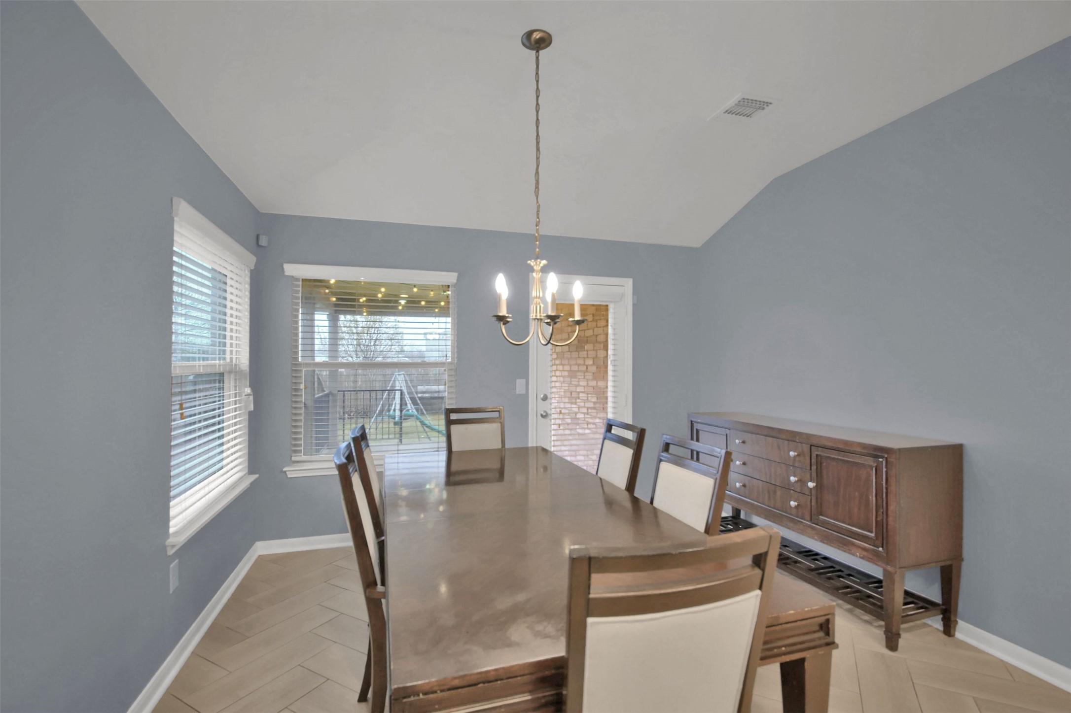 18005 Moreto Loop Pflugerville, TX 78660 - Photo 12 of 25 Dining area with a chandelier and lofted ceiling