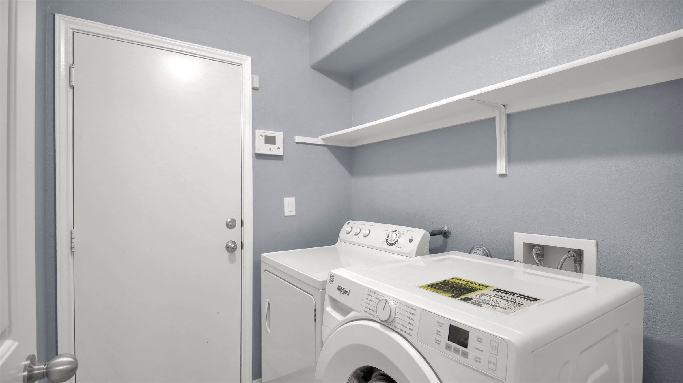 18005 Moreto Loop Pflugerville, TX 78660 - Photo 15 of 25 Laundry area with a textured wall and washing machine and clothes dryer