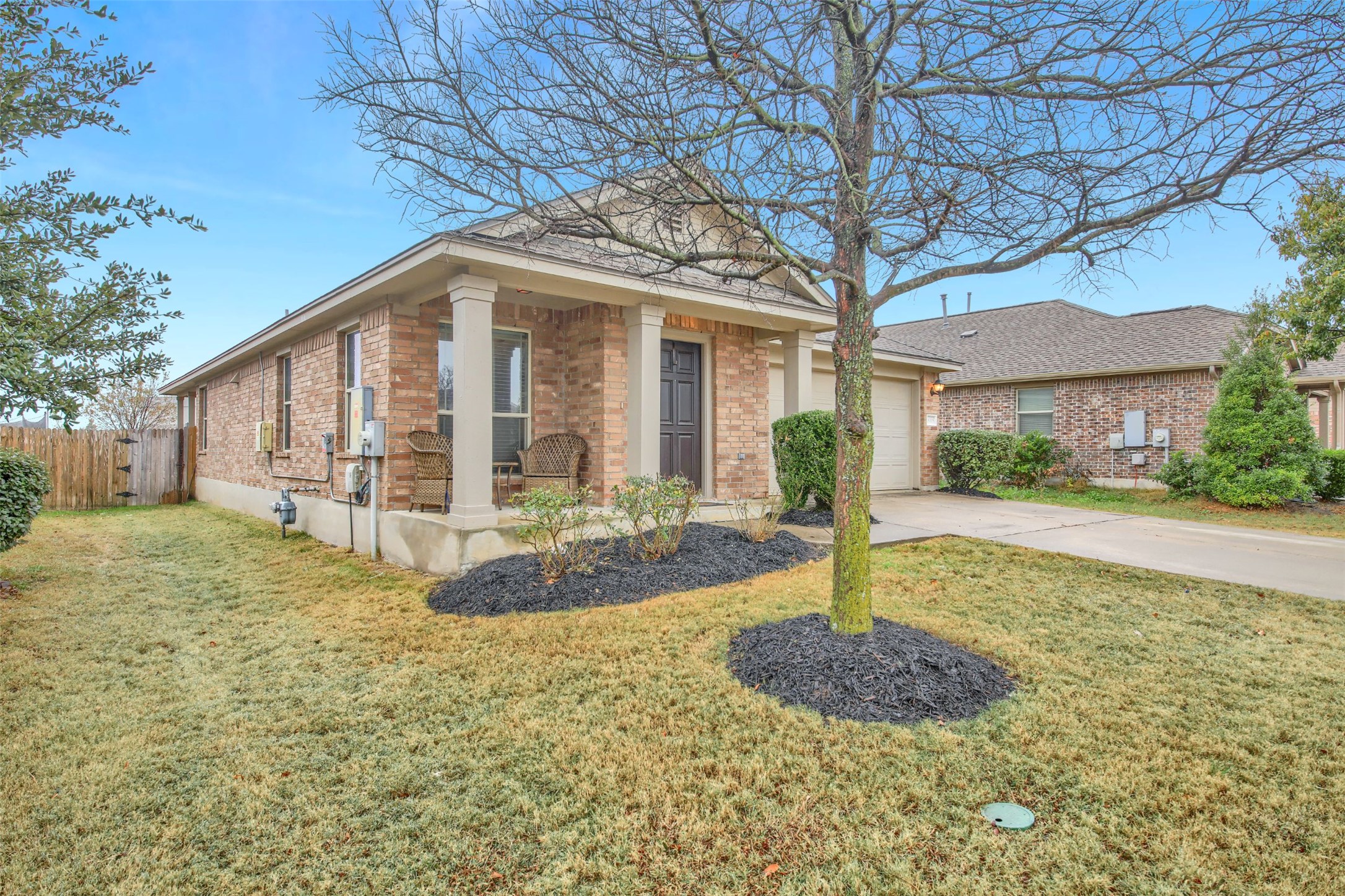18005 Moreto Loop Pflugerville, TX 78660 - Photo 2 of 25 View of front of house with concrete driveway, brick siding, and an attached garage