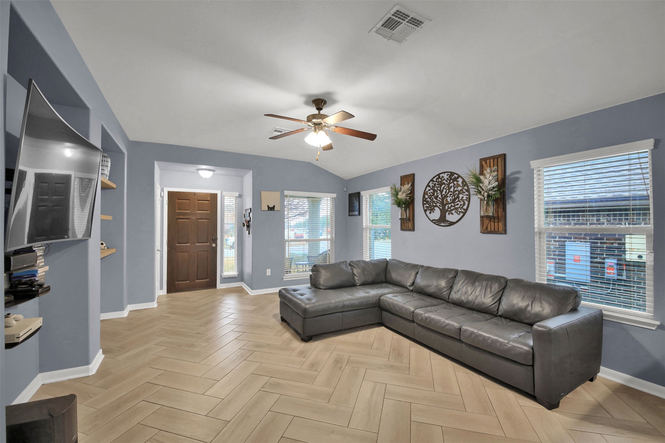 18005 Moreto Loop Pflugerville, TX 78660 - Photo 4 of 25 Living room with a ceiling fan, parquet flooring, healthy amount of natural light, and lofted ceiling