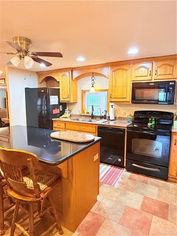 101 Rim Drive Mission, TX 78574 - Photo 7 of 17 a kitchen with stainless steel appliances granite countertop a stove a sink and a microwave
