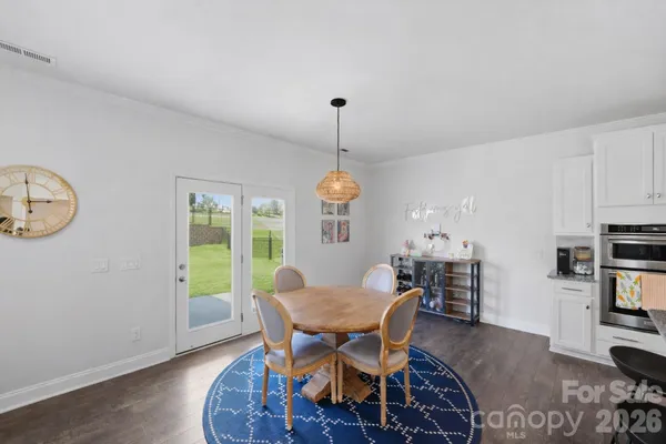 a dining room with furniture a window and wooden floor
