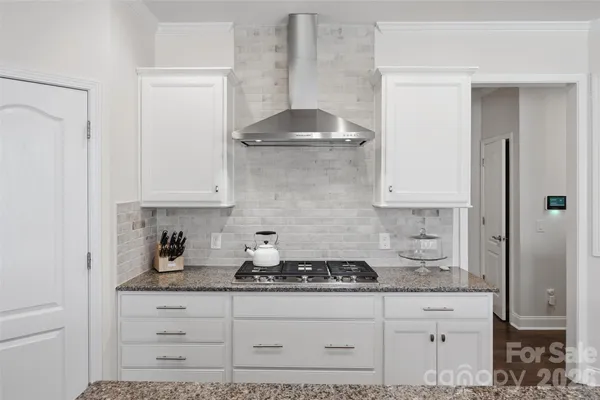 a kitchen with a stove and cabinets