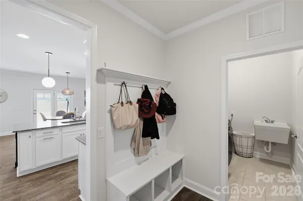 a walk in closet and a bathroom with sink