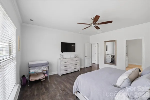 a bedroom with furniture and a flat screen tv