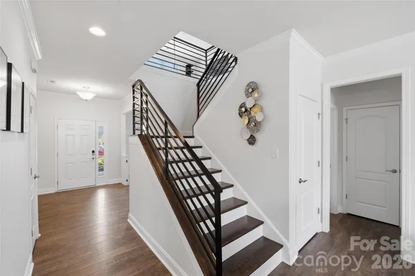 a view of entryway and hall with wooden floor