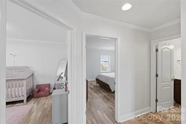 a view of a hallway with furniture and stairs