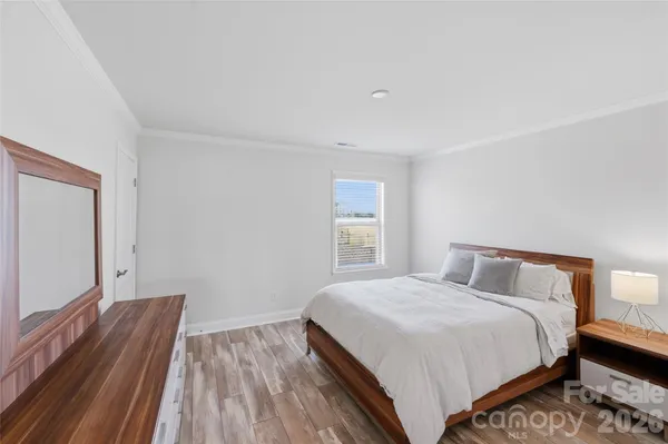 a bedroom with furniture and a window