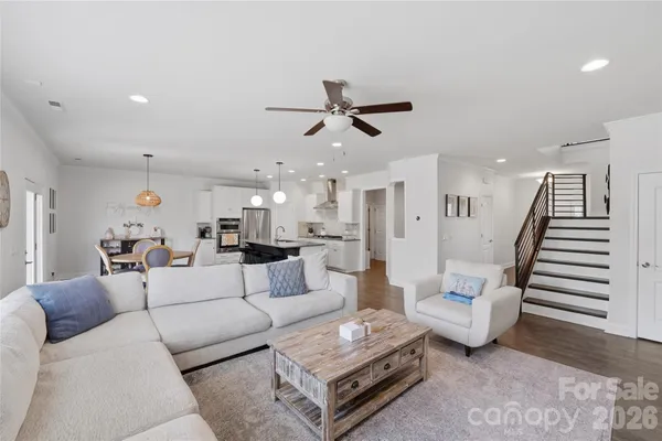 a living room with furniture and wooden floor