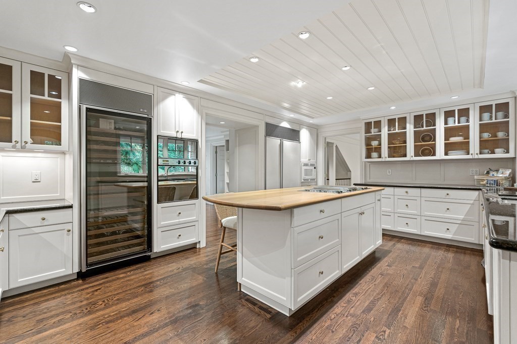 211 Meadowbrook Road Weston, MA 02493 - Photo 12 of 41 a large white kitchen with granite countertop a large window and a sink