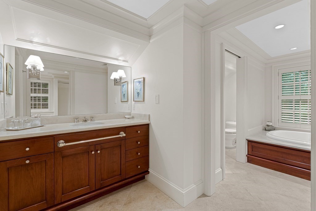 211 Meadowbrook Road Weston, MA 02493 - Photo 27 of 41 a spacious bathroom with a granite countertop sink and a mirror