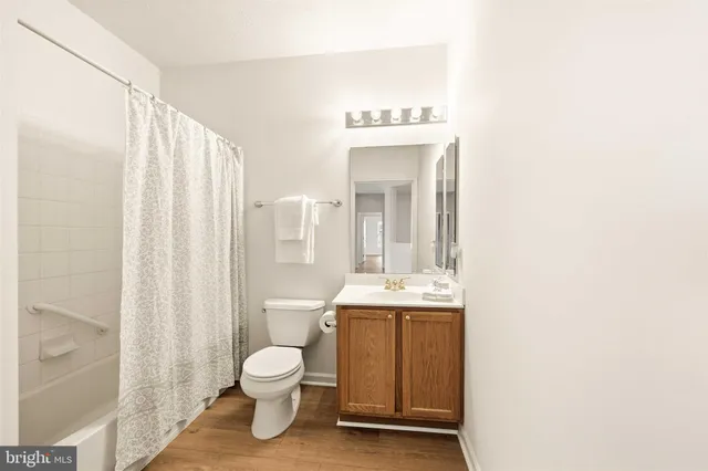 a bathroom with a toilet a sink and a mirror