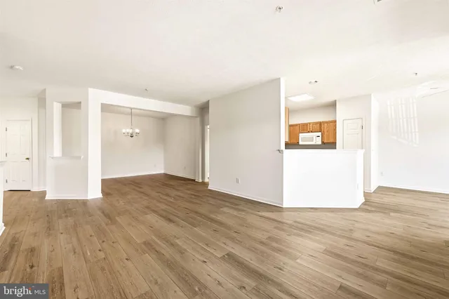 a view of an empty room and wooden floor