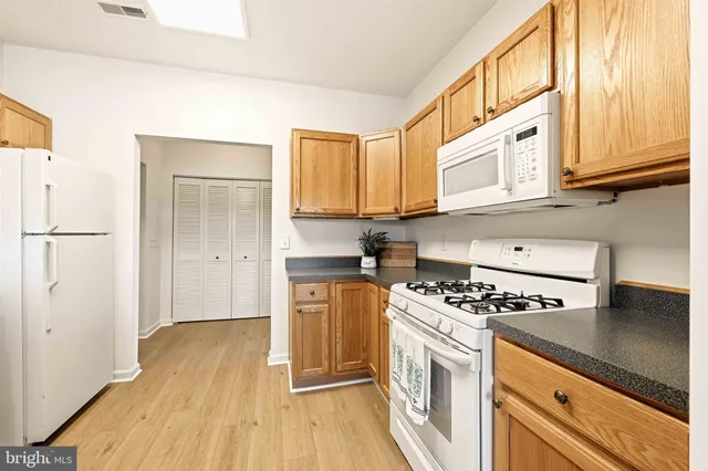 a kitchen with stainless steel appliances granite countertop a stove and a refrigerator