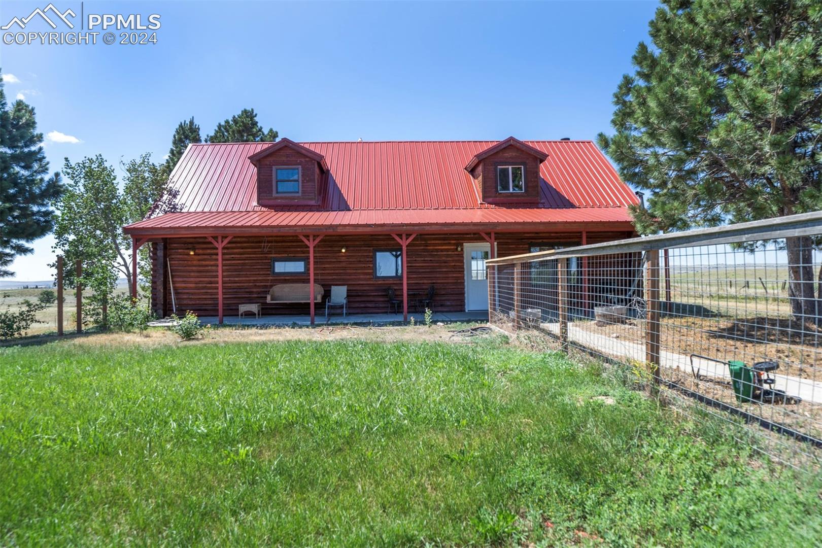 19350 Lemesany Road Calhan, CO 80808 - Photo 1 of 46 Log home with a front lawn