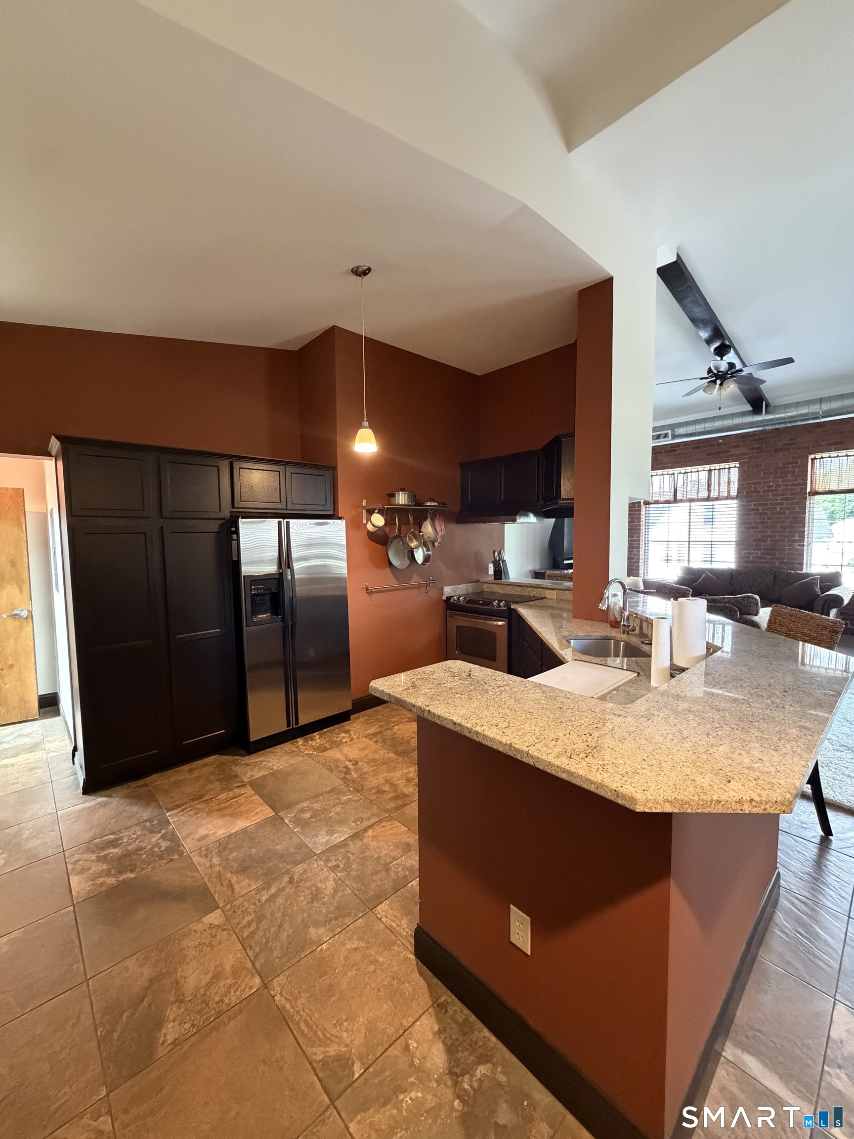 10 Summit Street, Unit 1 East Hampton, CT 06424 - Photo 4 of 14 a living room with stainless steel appliances kitchen island granite countertop a sink a stove and a wooden floors