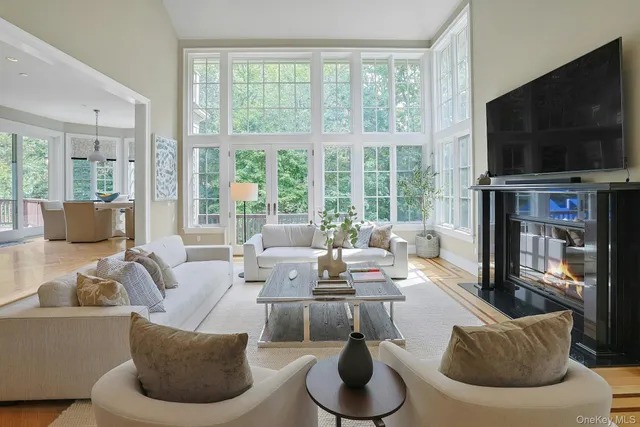 a spacious bathroom with sinks a large mirror and a bathtub next to a window