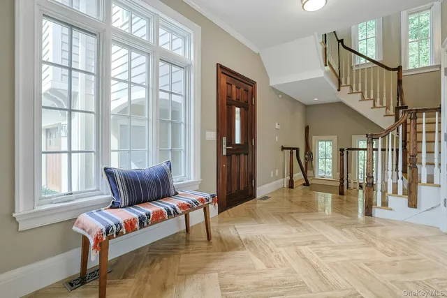 a dining room with furniture a chandelier and wooden floor