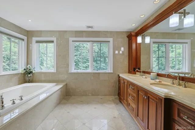 a view of a house with a big yard and large trees