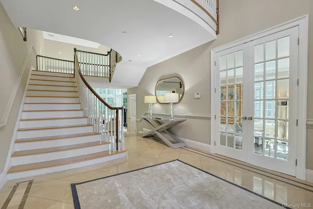 a view of entryway and hall with wooden floor