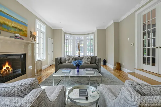 a dining room with furniture a chandelier and window