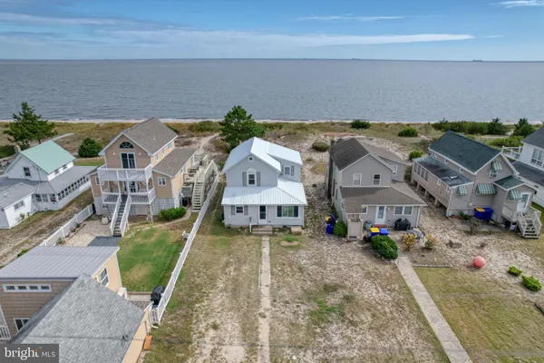 an aerial view of a house with a yard basket ball court and outdoor seating