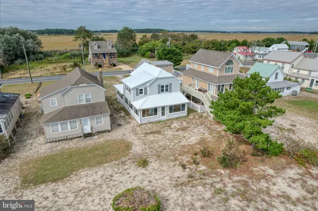 an aerial view of a house with a ocean view