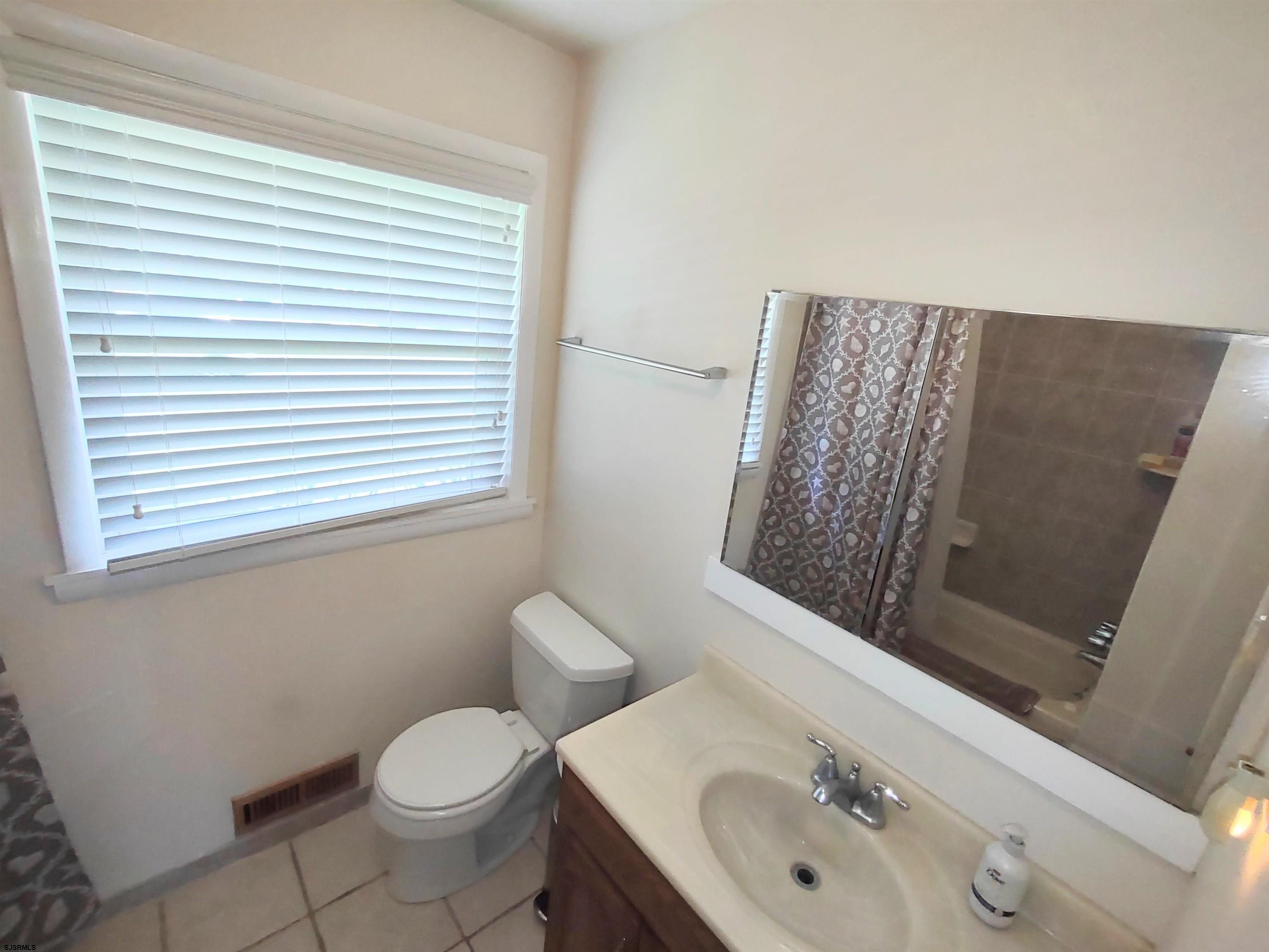 12 Osborne Road Somers Point, NJ 08244 - Photo 5 of 15 a bathroom with a toilet sink and mirror
