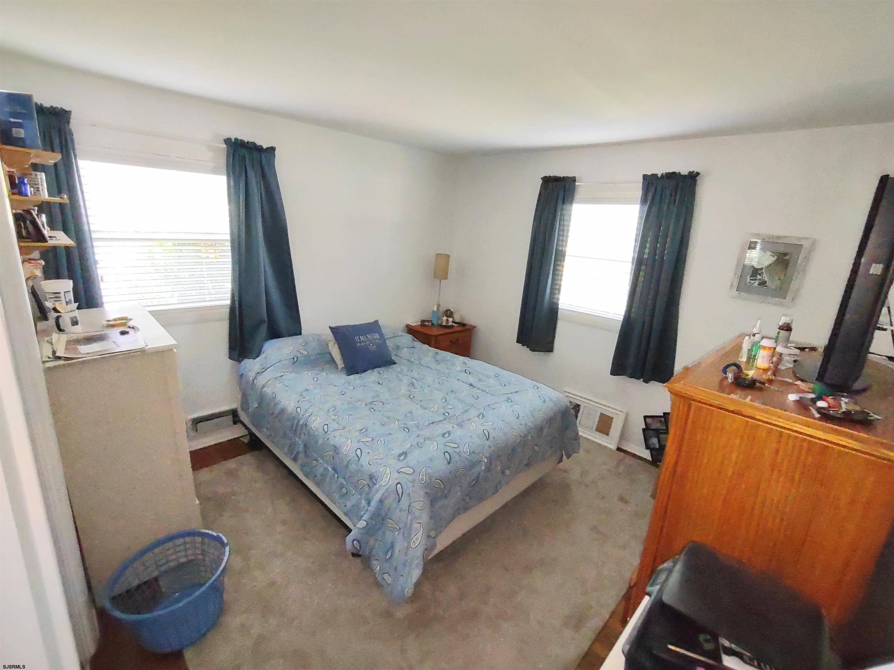12 Osborne Road Somers Point, NJ 08244 - Photo 7 of 15 a bedroom with a bed and a flat tv screen on the table