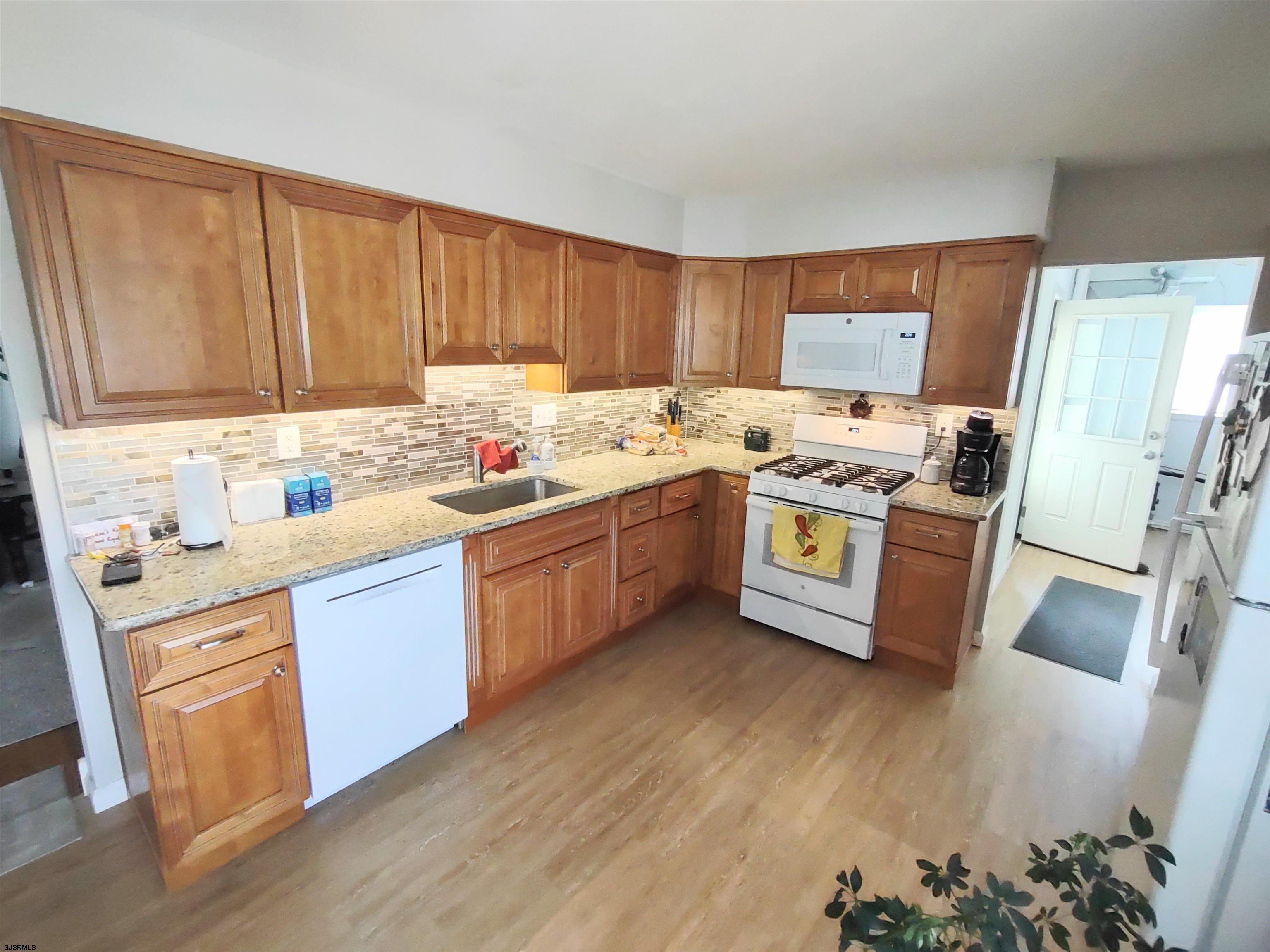 12 Osborne Road Somers Point, NJ 08244 - Photo 8 of 15 a kitchen with a sink stove and cabinets
