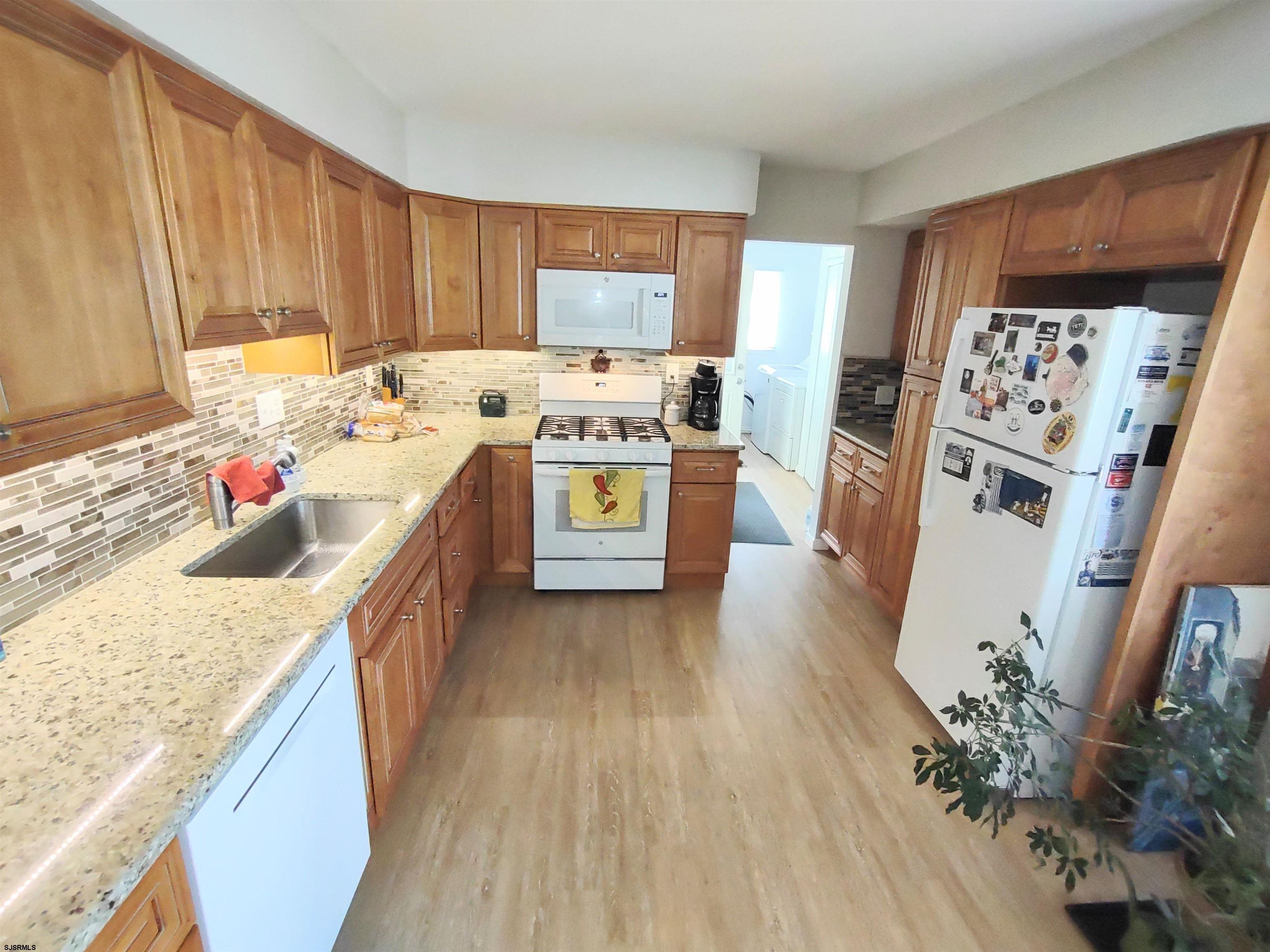 12 Osborne Road Somers Point, NJ 08244 - Photo 9 of 15 a kitchen with stainless steel appliances granite countertop a sink stove and refrigerator